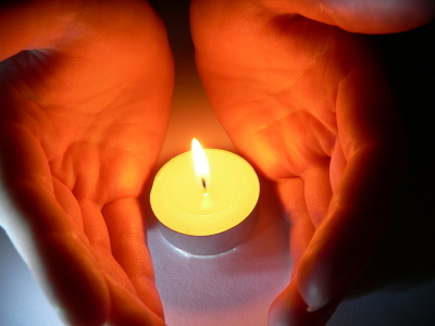 Hands Around Candle