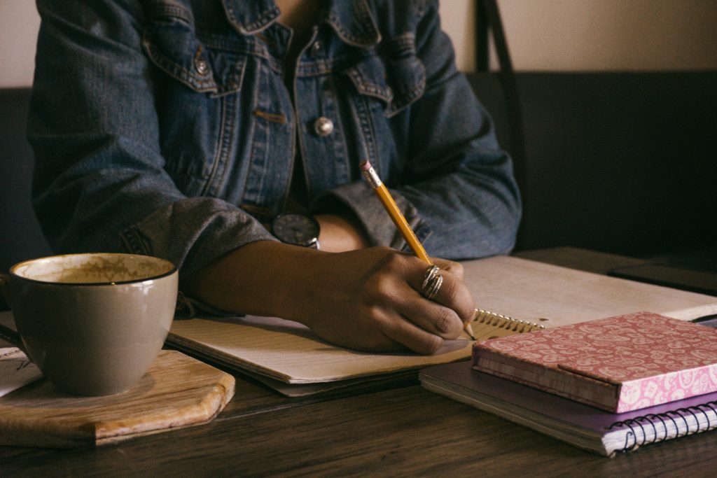 Photo of a woman writing at a table